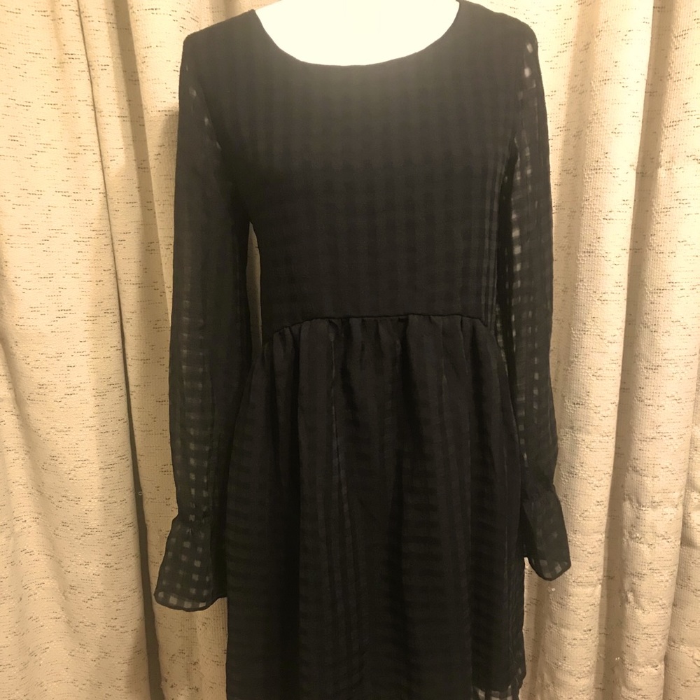 Black BCBG babydoll dress. Ruffled cuffs.